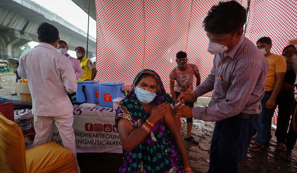 A woman receives a dose of COVAXIN coronavirus disease (COVID-19) vaccine